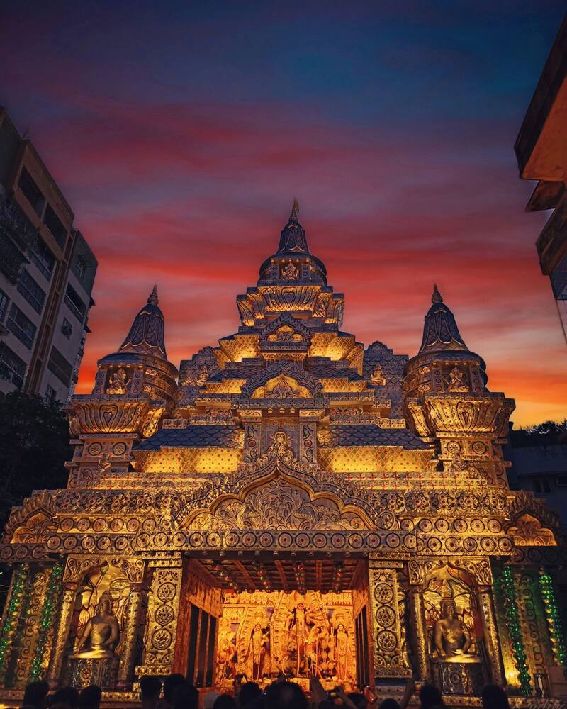 Kolkata Durga Puja pandal lit up at dusk